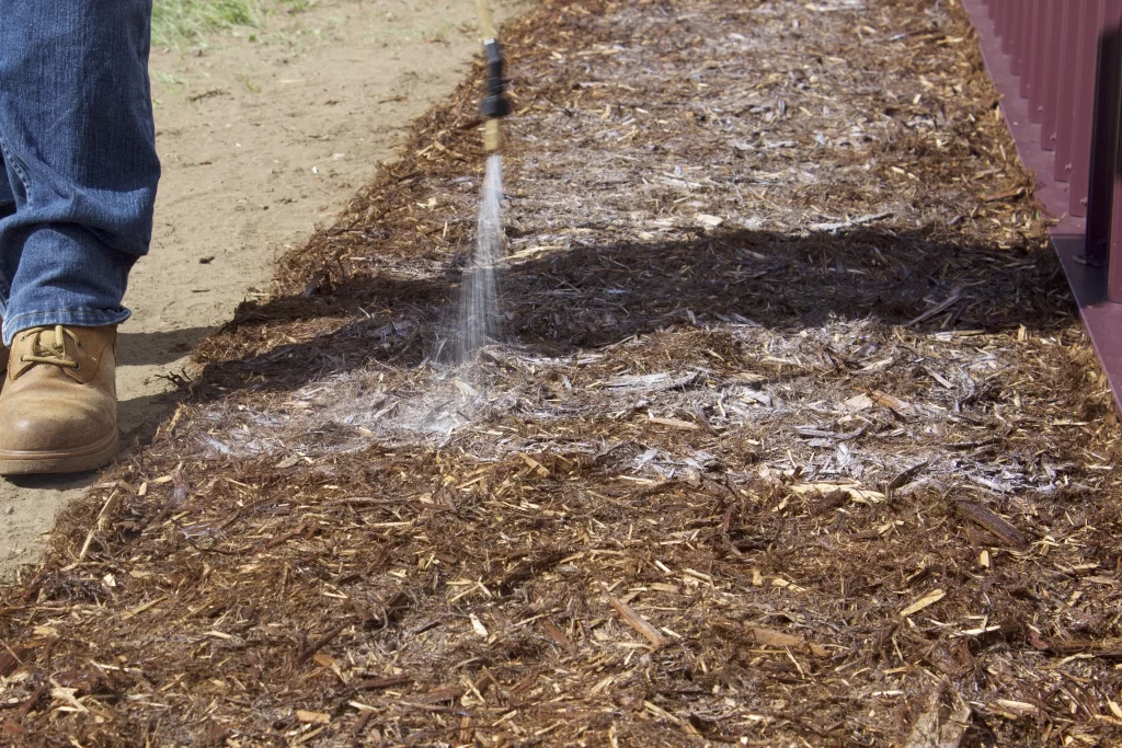 Mulch Stabilizer™ being applied to a outdoor mulched area in Texas.